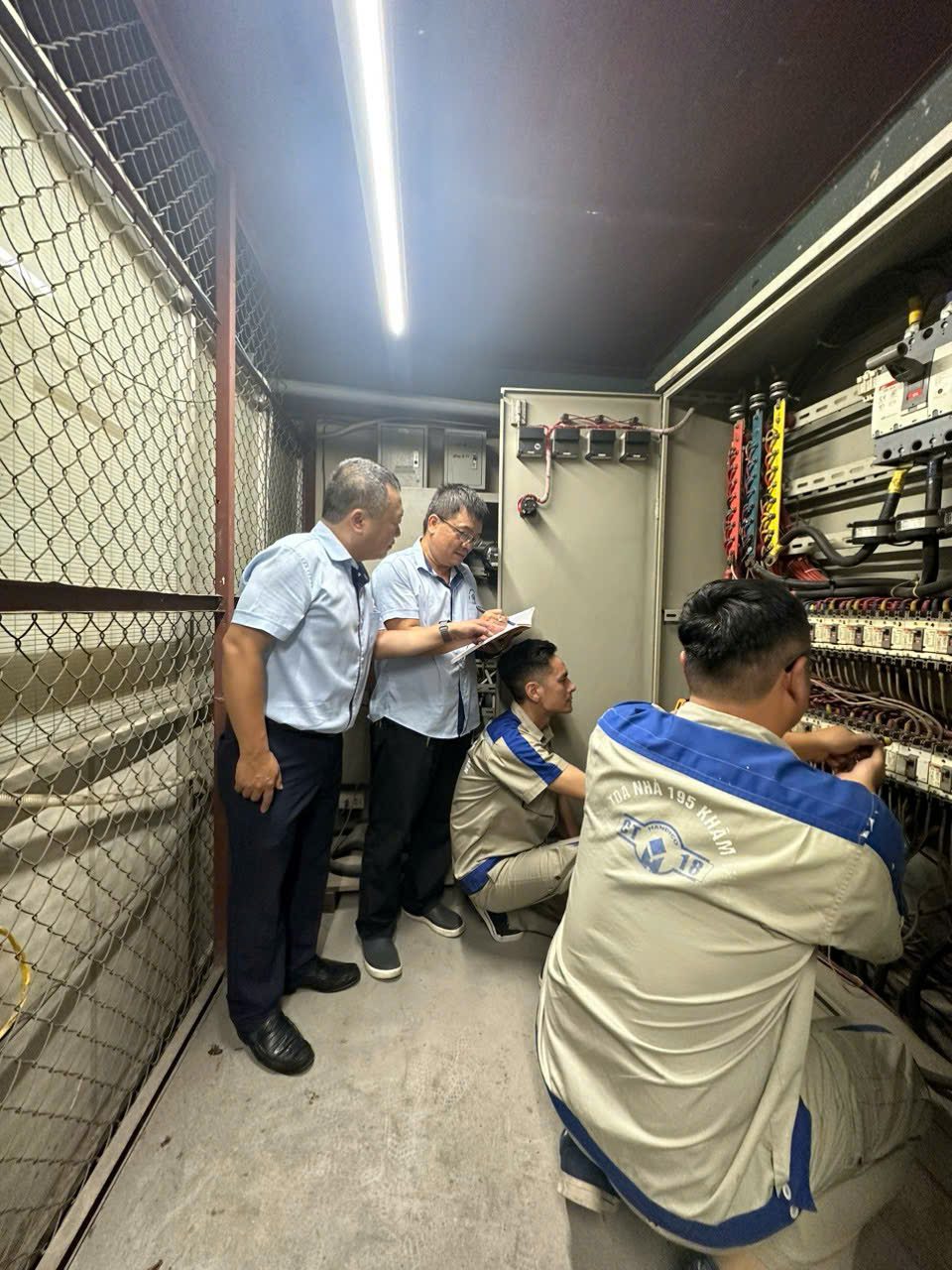 Tổ kỹ thuật kiểm tra tủ điện của tòa nhà, một phần việc của tám anh em giữ cho tòa nhà vận hành êm mỗi ngày.
